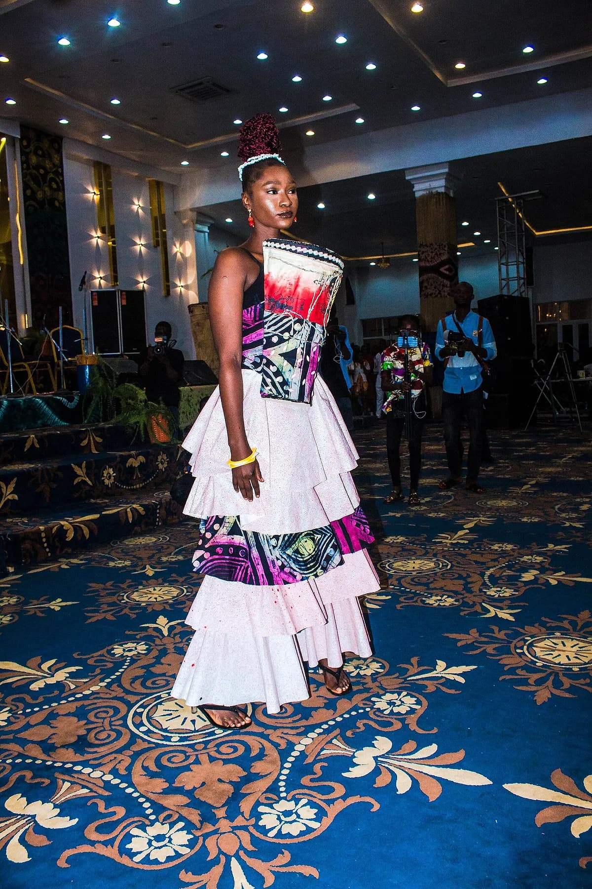 A woman wearing an outfit in adire patterned fabric.