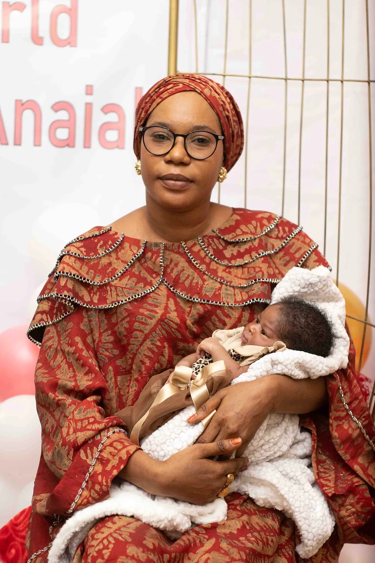 A woman holding a newborn baby.