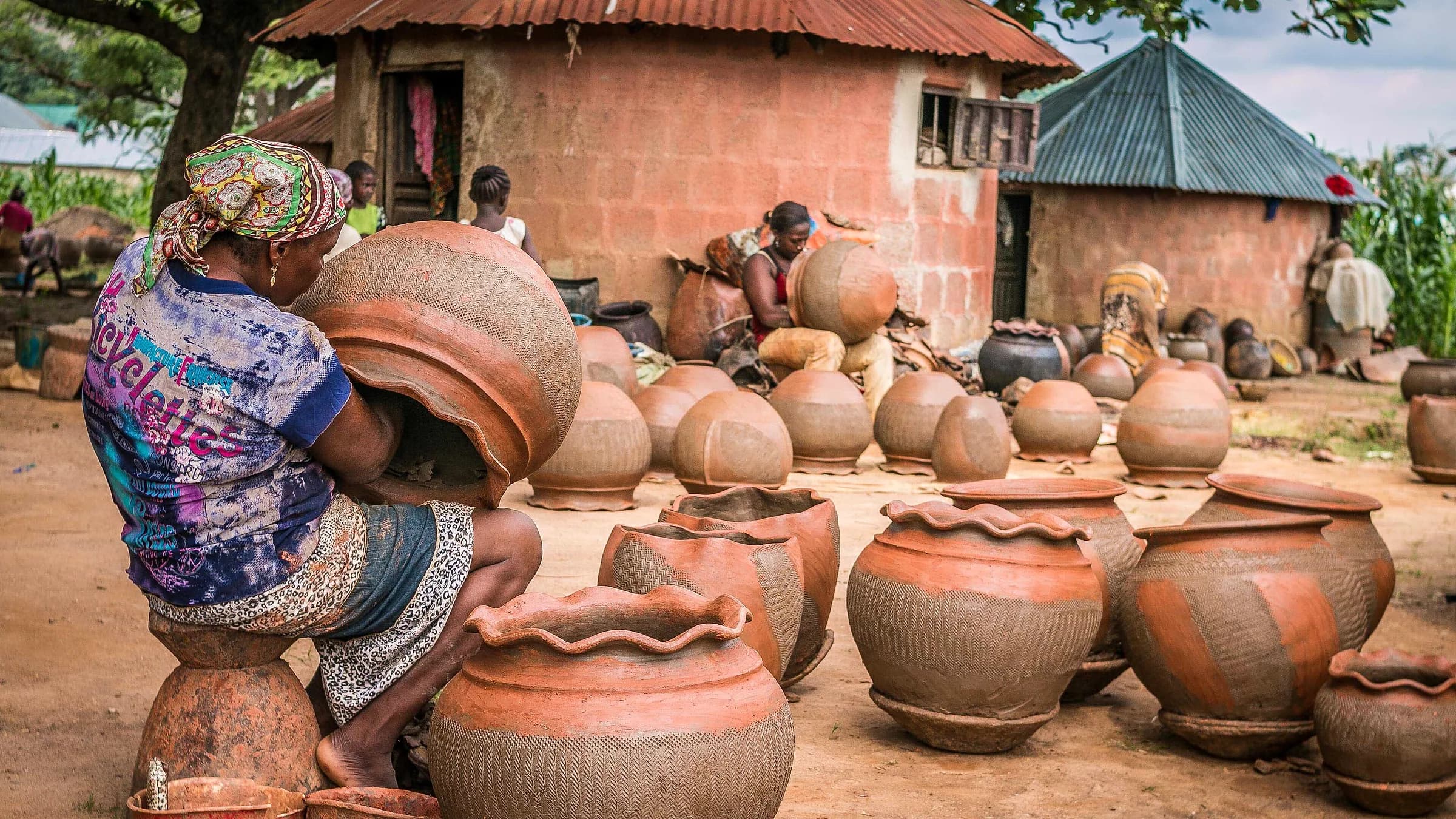 Women at work together in a village pottery co-operative.