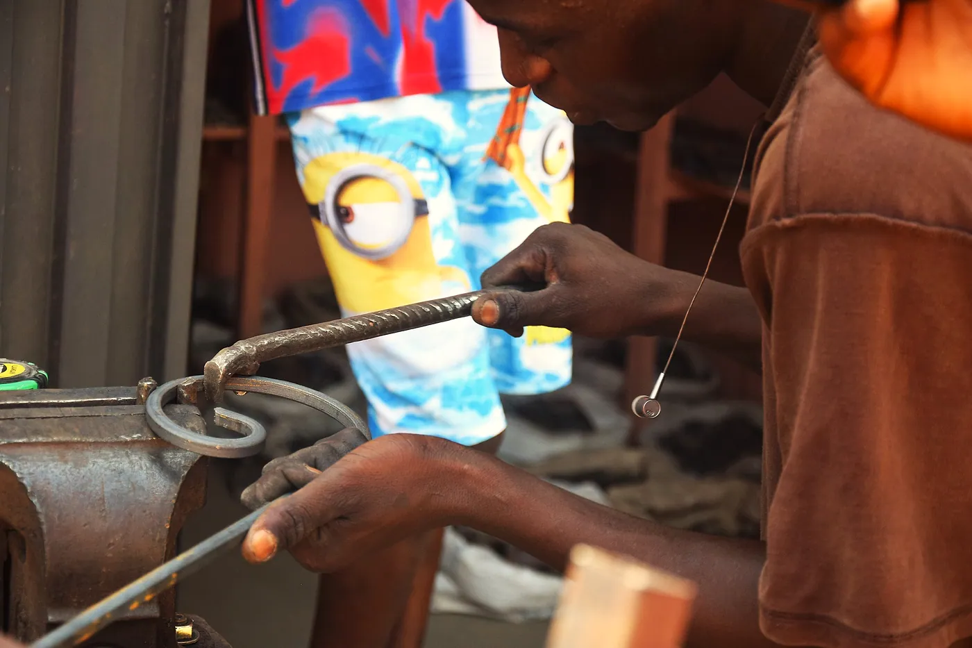 A craftsman at work turning a baluster.
